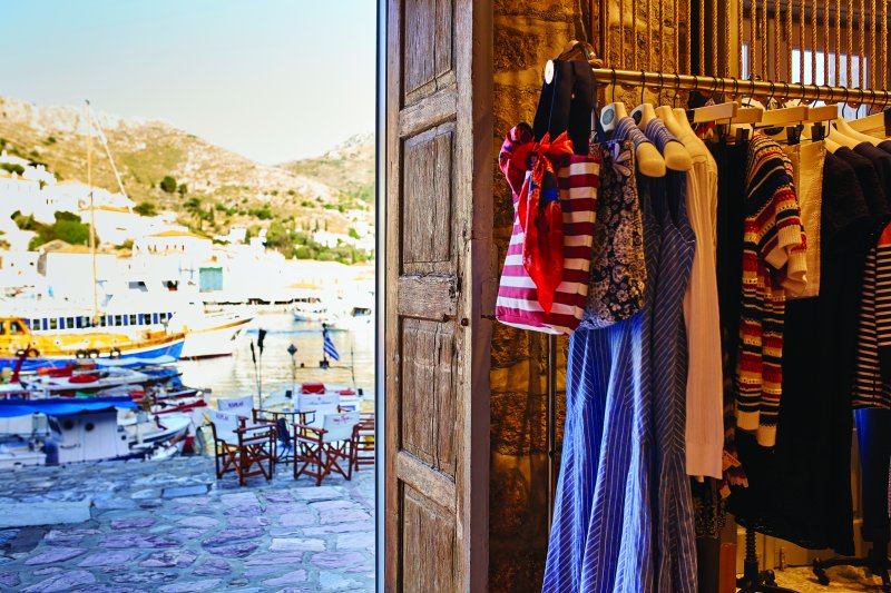 MyHydra Concept Store — colourful fashion on rails, harbour view through open door